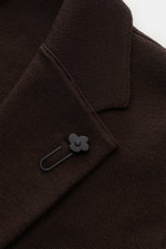 Close-up front view of the Lardini Knit blazer dark brown showing its fine knit pattern, tailored lapel with flower pin, and two-button style.

<p>With a classic silhouette and made from pure wool, the knit blazer by LARDINI brings style and personality t