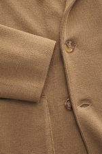 Close-up front view of Lardini Knitted blazer light brown showing fine knit pattern, soft wool texture, buttons, and patch pocket.