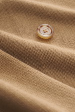 Close-up front view of a light brown button on fine knit fabric showcasing the texture of the Lardini Knitted blazer light brown.

Description: 
<p>With a classic silhouette and made from pure wool, the stylish knitted blazer by LARDINI perfects your smar