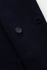Close-up front view of the navy button and buttonhole on the fine knit pattern of the Lardini Knitted blazer navy made from pure wool.

Description: 
<p>With a classic silhouette and made from pure wool, the stylish knitted blazer by LARDINI perfects your