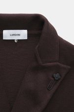 Lardini Knitted blazer dark brown close-up from above showing knit texture, lapel with flower pin, and label.  
With a classic silhouette and made from pure wool, the stylish knitted blazer by LARDINI perfects your smart casual wardrobe.  
- knit from pur