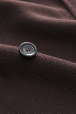 Close-up view of the Lardini Knitted blazer dark brown fabric showing a black four-hole button, highlighting the fine knit pattern and soft touch of the pure wool material.

Description: 
<p>With a classic silhouette and made from pure wool, the stylish k