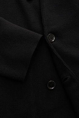 Close-up front view of the Lardini Knitted blazer black, showing fine knit pattern, buttons, and sleeve cuff, knit from pure wool, soft touch, slim fit, double-breasted three-button style, lapel with flower pin, rear side vents, patch hip pockets.