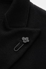 Close-up front view of Lardini Knitted blazer black showing soft pure wool knit, lapel with flower pin, and fine knit pattern.

Description: <p>With a classic silhouette and made from pure wool, the stylish knitted blazer by LARDINI perfects your smart ca