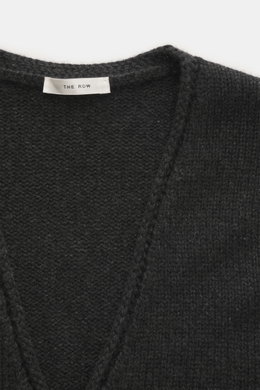 Close-up front view of The Row Cashmere Cardigan 'Manor' dark grey melange, showcasing its coarse knit, soft touch, and ribbed cuffs.
