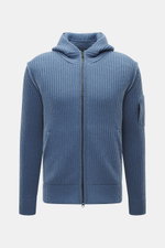 Vorderansicht der C.P. Company Strickjacke graublau mit Kapuze, voluminösem Strickbild, Slim Fit, Zwei-Wege-Reißverschluss, schrägen Taschen, Oberarm-Zipper-Tasche, weichem Schurwolle-Microfaser-Mix, labeltypischem Linsen-Detail.