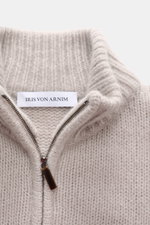 Close-up front view of Iris von Arnim Cashmere-silk cardigan 'Felias' sand, showing ribbed stand-up collar, two-way zipper, voluminous knit pattern, mix of cashmere and silk, slim fit, very soft feel, and comfortable ribbed cuffs.