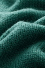 Nahaufnahme der Iris von Arnim Cashmere-Seide Strickjacke 'Felias' grün, zeigt voluminöses Strickbild, sehr weicher Griff, Mix aus Cashmere und Seide.