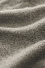Nahaufnahme des feinen Strickbildes der FTC Cashmere Strickjacke graugrün, weich und leicht mit geripptem Stehkragen.