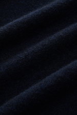 Close-up front view of the soft, fine-knit fabric of the FTC Cashmere cardigan navy, showcasing its lightweight, ribbed texture.