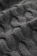 Close-up image showing the medium fine knit pattern and classic cable knit design of the Moorer Cashmere-silk cardigan 'Dean' dark grey melange, highlighting its mix of cashmere and silk for a very soft feel, photographed from a top-down perspective. The 