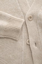 Close-up front view of 04651/ A trip in a bag Cardigan beige/sand patterned, rib knit of wool and cashmere, soft feel, medium-fine knit, subtle Norwegian pattern, Regular Fit, V-neck, four-button placket, comfortable ribbed cuffs.