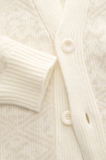 Close-up front view of 04651/ A trip in a bag Cardigan cream/beige patterned showing rib knit wool and cashmere, soft feel, medium-fine knit texture, subtle Norwegian pattern, Regular Fit, V-neck, four-button placket, and ribbed cuffs.