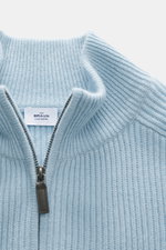 Close-up front top view of the von Braun Cashmere Cardigan light blue showing soft pure cashmere fabric, classic ribbed knit, high collar, and two-way zipper with leather pull.