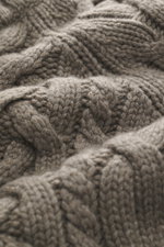 Close-up front view of the Brunello Cucinelli Cashmere cardigan grey-green showing its coarse cable knit texture and soft cashmere fibers.