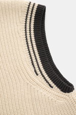 Close-up angled view of Ami Paris V-Neck Pullunder sand showing coarse rib knit wool and cotton, black contrast ribbed V-neck with stripes.

Description: <p>Layering-Piece von AMI PARIS: Der ikonische Pullunder mit V-Neck und typischem 'Ami'-Logo im Colle