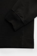 Black Stone Island Sweatshirt 'Ghost Piece' close-up from sleeve and hem perspective, showing soft, slightly elastic cotton fabric. <p>With this sweatshirt in stretch cotton with tonal compass badge on the sleeve, STONE ISLAND offers a comfortable all-rou