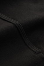 Close-up detail of the black fabric and stitching of the Stone Island Sweatshirt 'Ghost Piece' black, photographed from a macro perspective.

<p>With this sweatshirt in stretch cotton with tonal compass badge on the sleeve, STONE ISLAND offers a comfortab