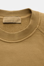 Stone Island Crew neck sweatshirt 'Ghost Piece' light brown shown close-up from above, highlighting ribbed collar and fabric texture. 

A timeless basic piece: This sporty sweatshirt from the 'Ghost' Capsule Collection by STONE ISLAND provides the perfect