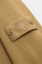 Close-up of the tonal compass badge on the upper sleeve of the Stone Island Crew neck sweatshirt 'Ghost Piece' light brown, showing knit fabric texture.

Description:  
<p>A timeless basic piece: This sporty sweatshirt from the 'Ghost' Capsule Collection 