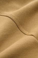 Close-up fabric detail of the Stone Island Crew neck sweatshirt 'Ghost Piece' light brown, photographed from a macro perspective showing the textured knit and stitching.

Description: 
<p>A timeless basic piece: This sporty sweatshirt from the 'Ghost' Cap