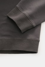 Close-up front view of the Stone Island Crew neck sweatshirt 'Stellina' anthracite sleeve cuff and hem, showing soft elasticated cotton fabric and subtle Stellina stitching.

Description: 
<p>Understated aesthetic meets precision: The sweatshirt 'Stellina