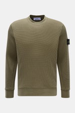 Front view of Stone Island Rundhalspullover 'Waffle' oliv, an olive green slim-fit crewneck sweater in waffle knit with sweat cuffs and compass badge on upper arm. 

<p>Basic Piece mit Twist: Dieser Pullover im Waffelstrick von STONE ISLAND wird zur ideal