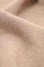 Close-up angled view of Stone Island Crew neck sweatshirt 'Washed Sweat' beige showing soft cotton fabric texture with authentic washed effect.

Description: <p>STONE ISLAND’s signature piece dyeing is used with a modern washed effect in this sweatshirt a