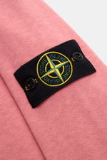 Close-up side view of Stone Island Crew neck sweatshirt 'Washed Sweat' antique pink showing the compass badge on the upper sleeve.

Description: <p>STONE ISLAND’s signature piece dyeing is used with a modern washed effect in this sweatshirt and external s