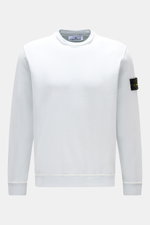 Stone Island Crew neck sweatshirt 'Washed Sweat' pastel blue shown front view, made of pure cotton with soft feel, washed effect, external collar seams, compass badge on upper sleeve, regular fit, ribbed bands for comfort.