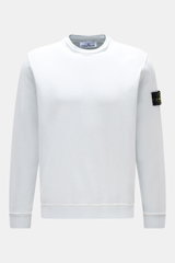 Stone Island Crew neck sweatshirt 'Washed Sweat' pastel blue shown front view, made of pure cotton with soft feel, washed effect, external collar seams, compass badge on upper sleeve, regular fit, ribbed bands for comfort.