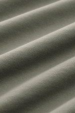 Close-up front-angle view of fabric texture in a garment dyed C.P. Company Sweatshirt salbei, showing soft, lightweight cotton knit with fine ribbing and smooth folds. <article class="text-token-text-primary w-full focus:outline-none [--shadow-height:45px