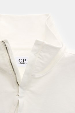 Nahaufnahme des offwhite C.P. Company Sweat-Troyer aus leichtem Baumwoll-Sweat, Perspektive von oben auf den geöffneten Troyer-Kragen mit Reißverschluss.