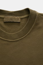 Stone Island Sweatshirt 'Ghost Piece' oliv, Detailaufnahme von oben, Rundhalsausschnitt, tonales Kompass-Badge, elastische Baumwollqualität, Regular Fit, weicher Griff.