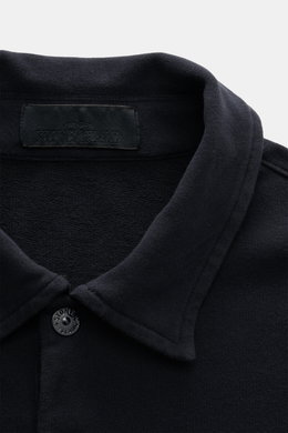 Nahaufnahme von Stone Island Longsleeve Sweat-Poloshirt 'Ghost Piece' navy, weicher Baumwollsweat mit Polokragen und Stone Island-Patch am Oberarm, fotografiert aus frontaler Perspektive.