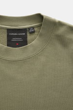 Close-up top view of Canada Goose Sweatshirt 'Loon' grey green showing crew neckline, ribbed cuffs, and woven label inside collar.

Description: <p>Comfort 24/7 offers the lightweight 'Loon' sweatshirt made of pure cotton by CANADA GOOSE, which complement