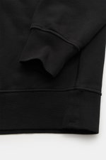 Stone Island Crew Neck Sweatshirt 'Basic Sweat' black shown from a close-up side angle focusing on cuff and hem, made of pure cotton with soft touch, regular fit, crew neckline, compass badge on upper arm, and ribbed cuffs.