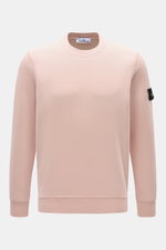 Front view of Stone Island Crew Neck Sweatshirt 'Basic Sweat' rose in soft rose color, made of pure cotton with regular fit, crew neckline, ribbed cuffs, and compass badge on upper arm. Timeless basic piece ideal for casual leisure looks and versatile all