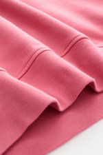 Close-up front view of Stone Island Crewneck Sweatshirt 'Basic Sweat' magenta showing soft cotton fabric, ribbed cuffs, and stitching details.

Description: 
<p>Timeless Basic Piece: The sporty sweatshirt by STONE ISLAND becomes the ideal foundation for c