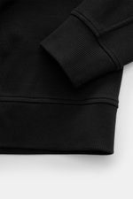 Close-up from above of the Stone Island R-Neck Longsleeve black showing rib knit fabric, flexible sleeve cuff, and hem details.

<p>Autumn essential: The STONE ISLAND long sleeve combines a characteristic rib knit structure with timeless versatility.</p>
