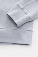 Close-up front view of the Stone Island R-Neck Longsleeve smoky blue showing fine ribbed knit cotton fabric, flexible cuffs, and subtle stitching.

<p>Autumn essential: The long sleeve by STONE ISLAND combines characteristic ribbed knit structure with tim