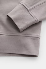 Stone Island R-Neck Longsleeve grey shown in close-up from above, highlighting fine ribbed knit, slim fit, and flexible cuff.