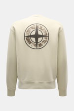 Stone Island Sweatshirt 'Print' beige shown from the back, featuring a wind rose print, made of soft pure cotton with ribbed cuffs.

Casual comfort meets iconic design: With this sweatshirt, STONE ISLAND presents a cool piece for your casual wardrobe. Fea
