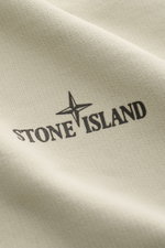 Close-up front view of Stone Island Sweatshirt 'Print' beige showing soft cotton fabric with distinctive black STONE ISLAND logo and compass print.

Description: <p>Casual comfort meets iconic design: With this sweatshirt, STONE ISLAND presents a cool pie
