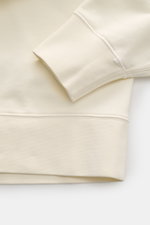 Close-up view of the cream Stone Island Sweatshirt 'Print' showing ribbed cuff, soft cotton fabric, and detailed stitching from a top angle.

Description: <p>Casual comfort meets iconic design: With this sweatshirt, STONE ISLAND presents an essential piec