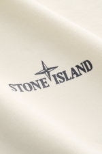 Close-up front view of the Stone Island Sweatshirt 'Print' cream showing the distinctive compass and Stone Island logo on soft cotton fabric. 

Description: Casual comfort meets iconic design: With this sweatshirt, STONE ISLAND presents an essential piece