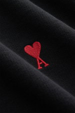 Close-up front view of the Ami Paris Crewneck Sweatshirt black showing the red embroidered heart logo on soft pure cotton fabric.

<p>Comfortable basic: The AMI PARIS sweatshirt made of pure cotton is the ideal companion for sporty looks.</p>
<ul>
<li>swe