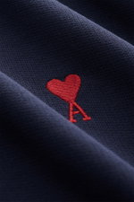 Close-up, angled view of the Ami Paris Crewneck Sweatshirt navy showing soft pure cotton fabric and red heart logo stitching on the chest.
