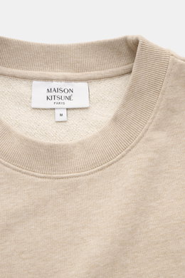 Close-up front view of Maison Kitsuné Beige Melange Sweatshirt showing round neckline and label inside collar in beige melange color.

<p>Cool essential from MAISON KITSUNÉ: With the typical fox patch on the chest, this sweater becomes a favorite piece in