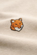 Close-up front view of the Maison Kitsuné Beige Melange Sweatshirt showing the detailed fox patch on beige cotton fabric.

<p>Cool essential from MAISON KITSUNÉ: With the typical fox patch on the chest, this sweater becomes a favorite piece in your casual